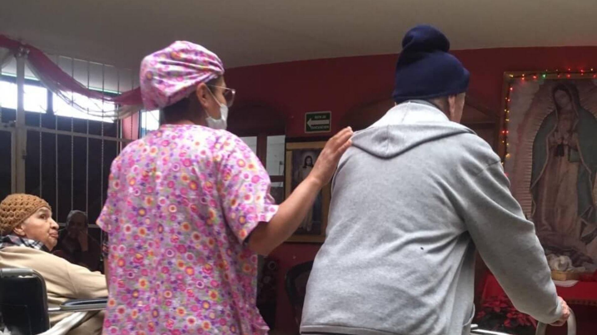 thumbnail of nurse walking with an elderly resident