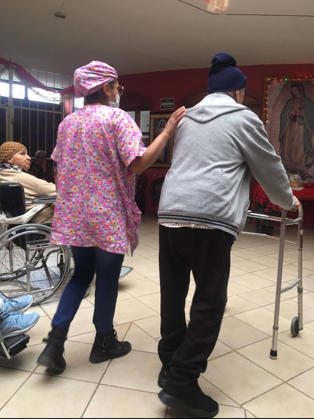 nurse walking with an elderly resident