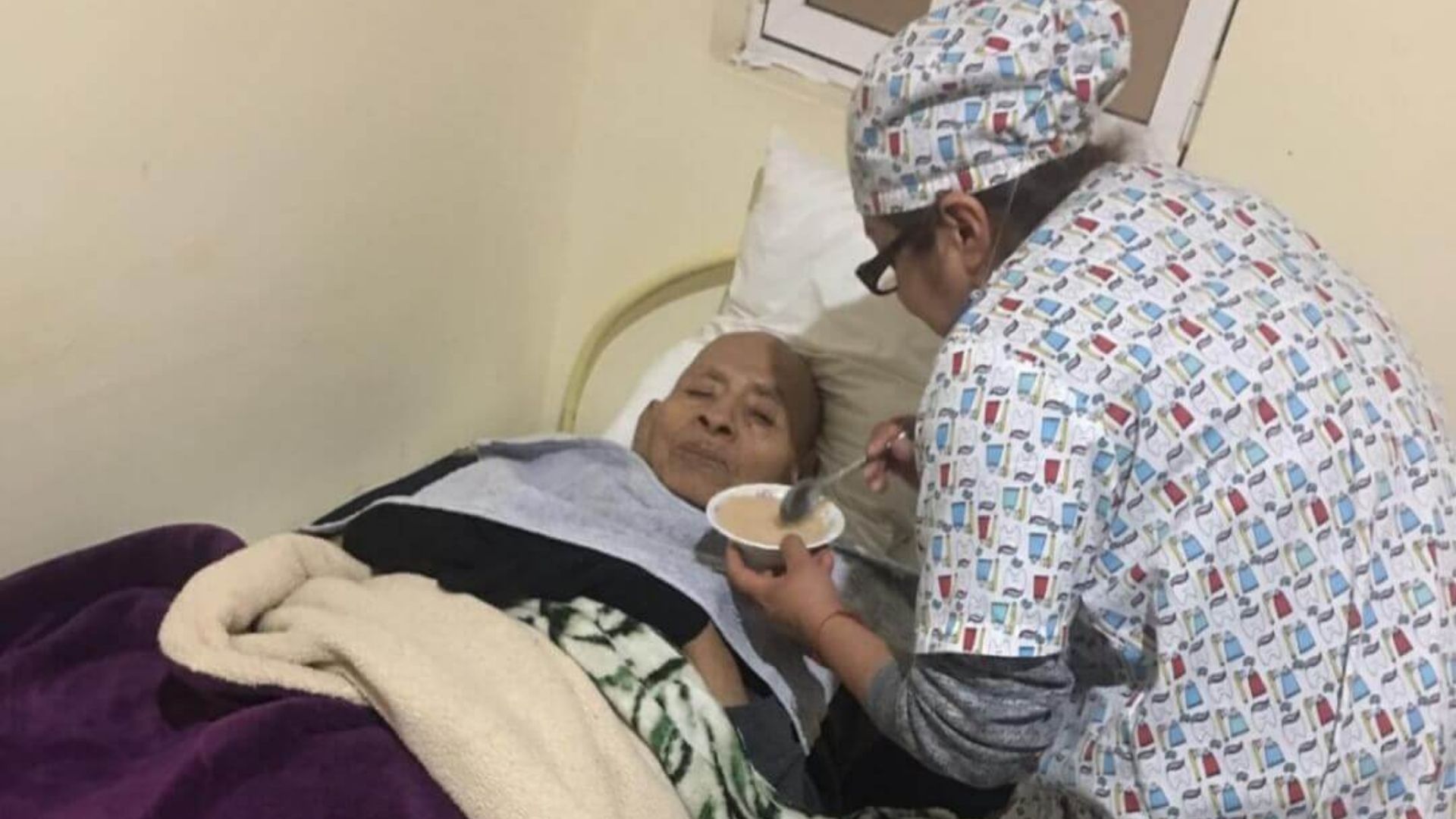 thumbnail of nurse feeding an elderly resident