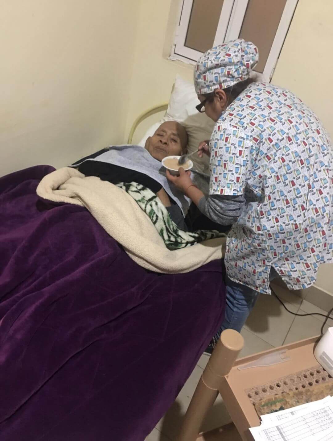thumbnail of nurse feeding an elderly resident