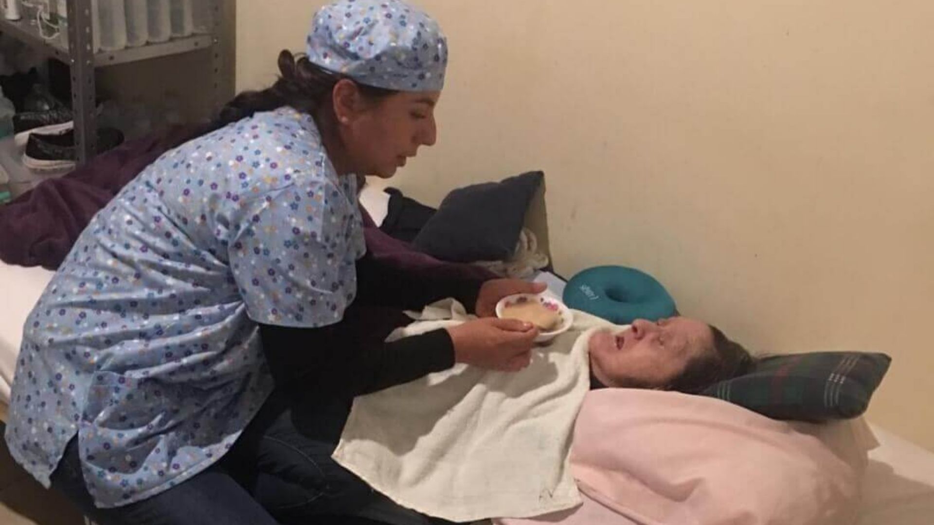 thumbnail of nurse feeding an elderly resident