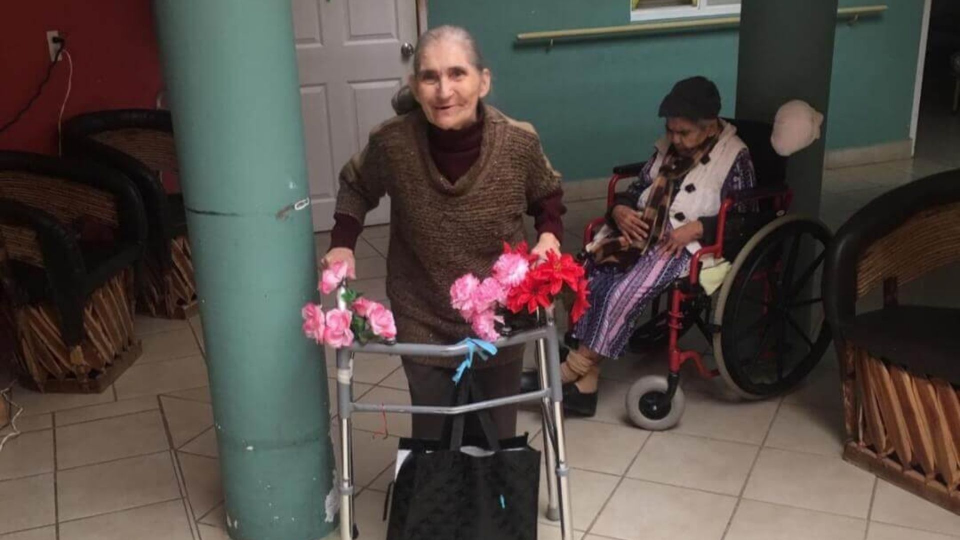 thumbnail of resident walking with her walker