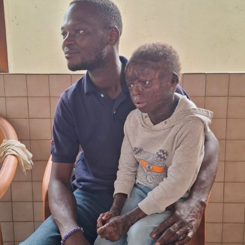 thumbnail of a boy sitting on the lap of a man