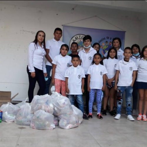 thumbnail of children posing together with bags of food
