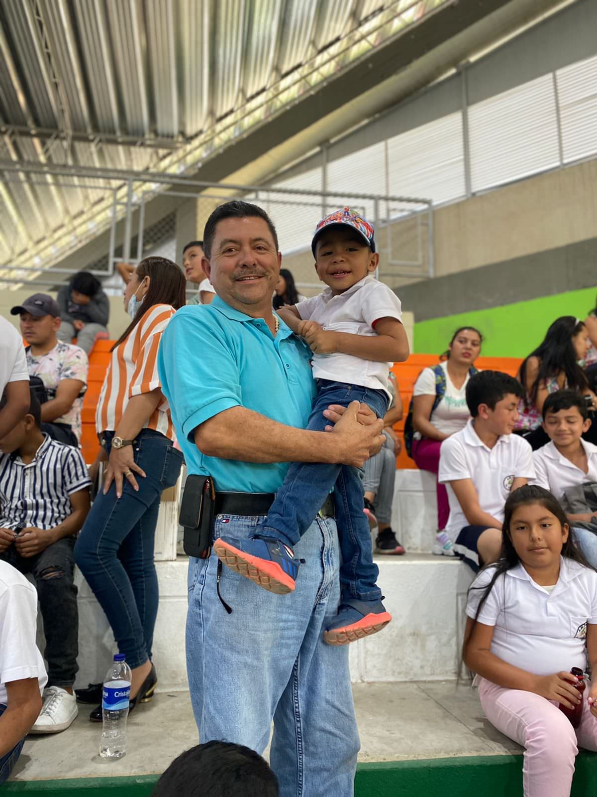 a man holding a child while smiling