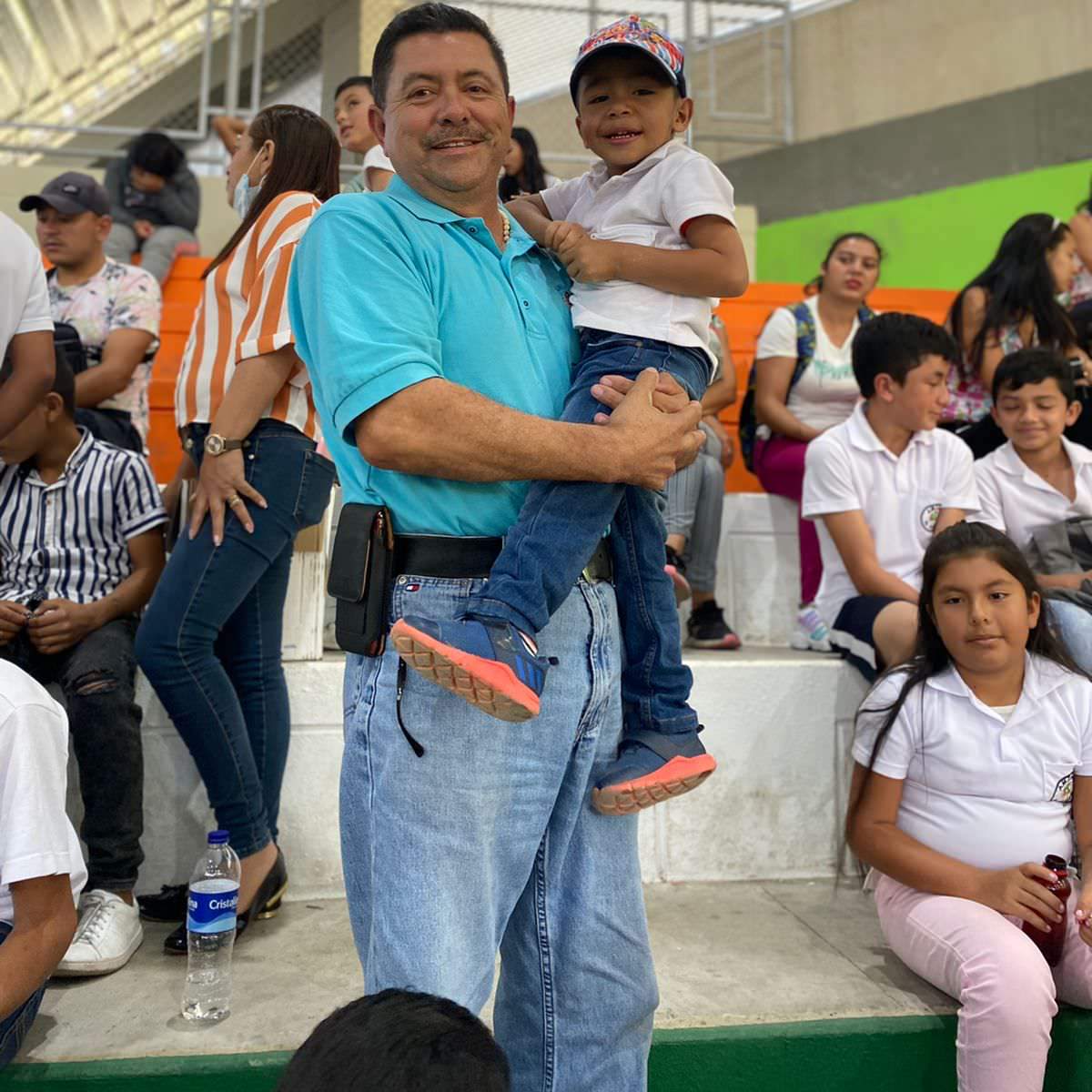 thumbnail of a man holding a child while smiling