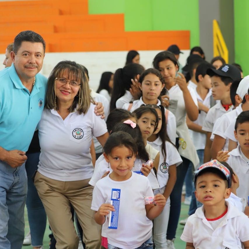 thumbnail of a man and woman pose with children holding snacks