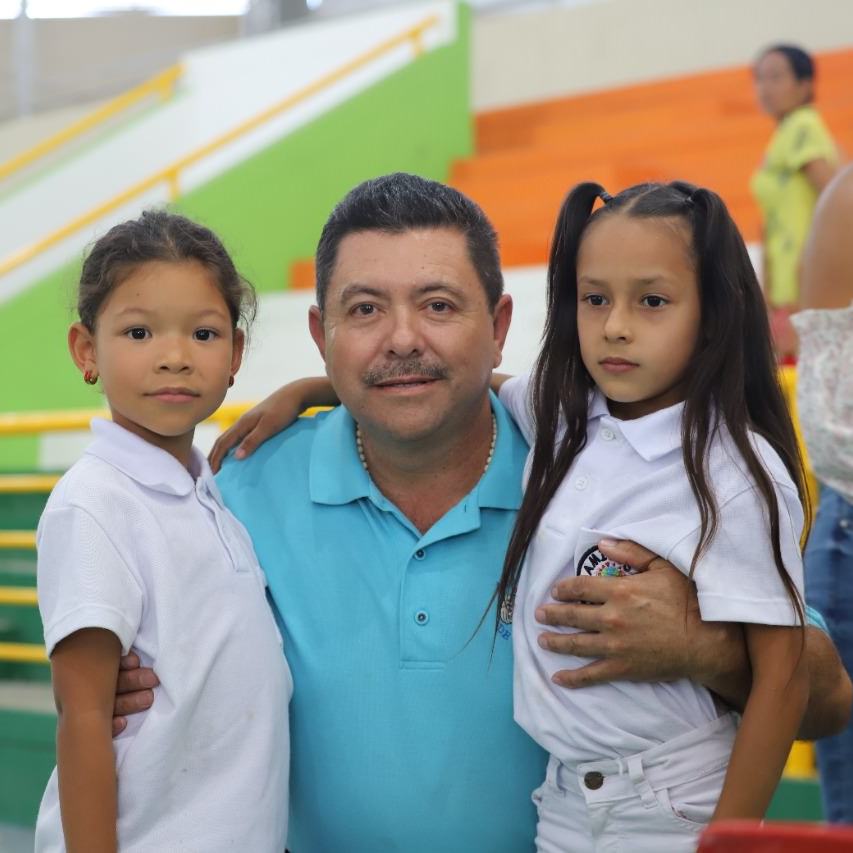 thumbnail of a man poses with 2 children