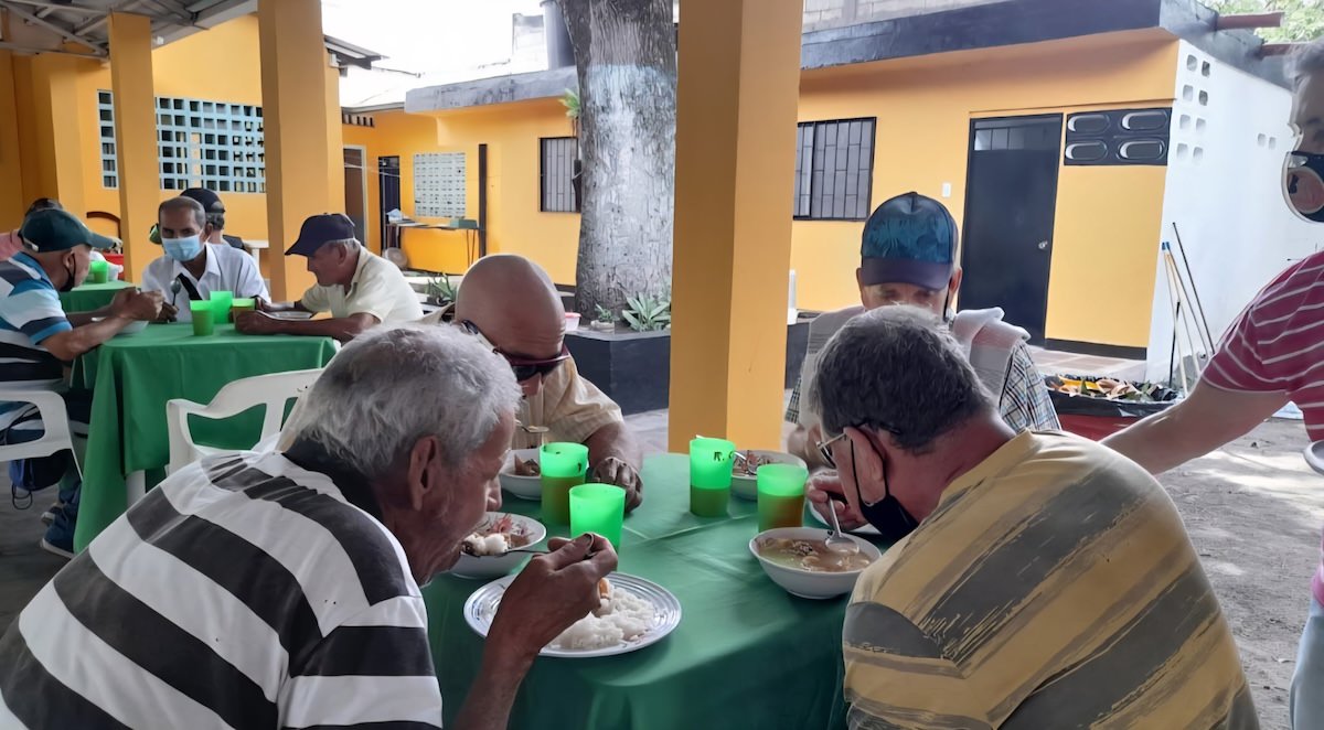a table of men eating food