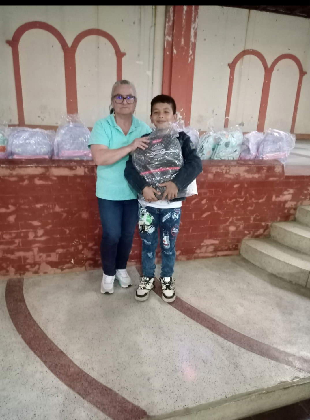 a boy receives a backpack