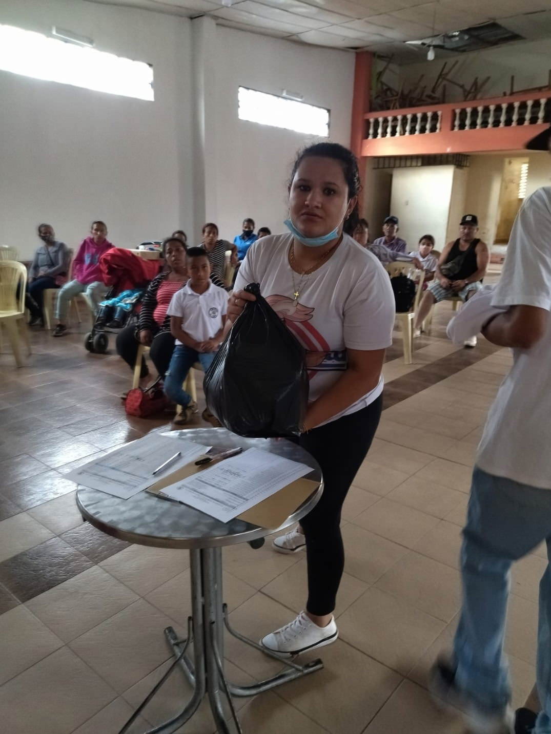 a woman receives a bag of food