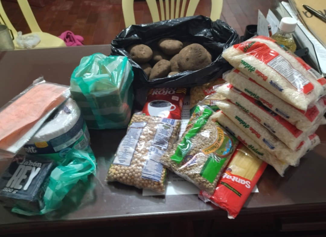 table with bags of potatoes, rice and beans