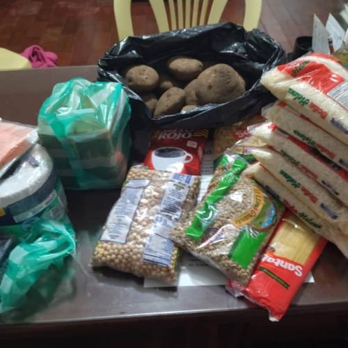 thumbnail of table with bags of potatoes, rice and beans