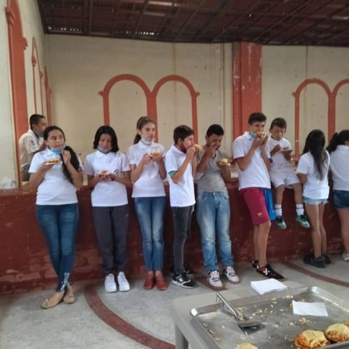 thumbnail of children standing and eating food